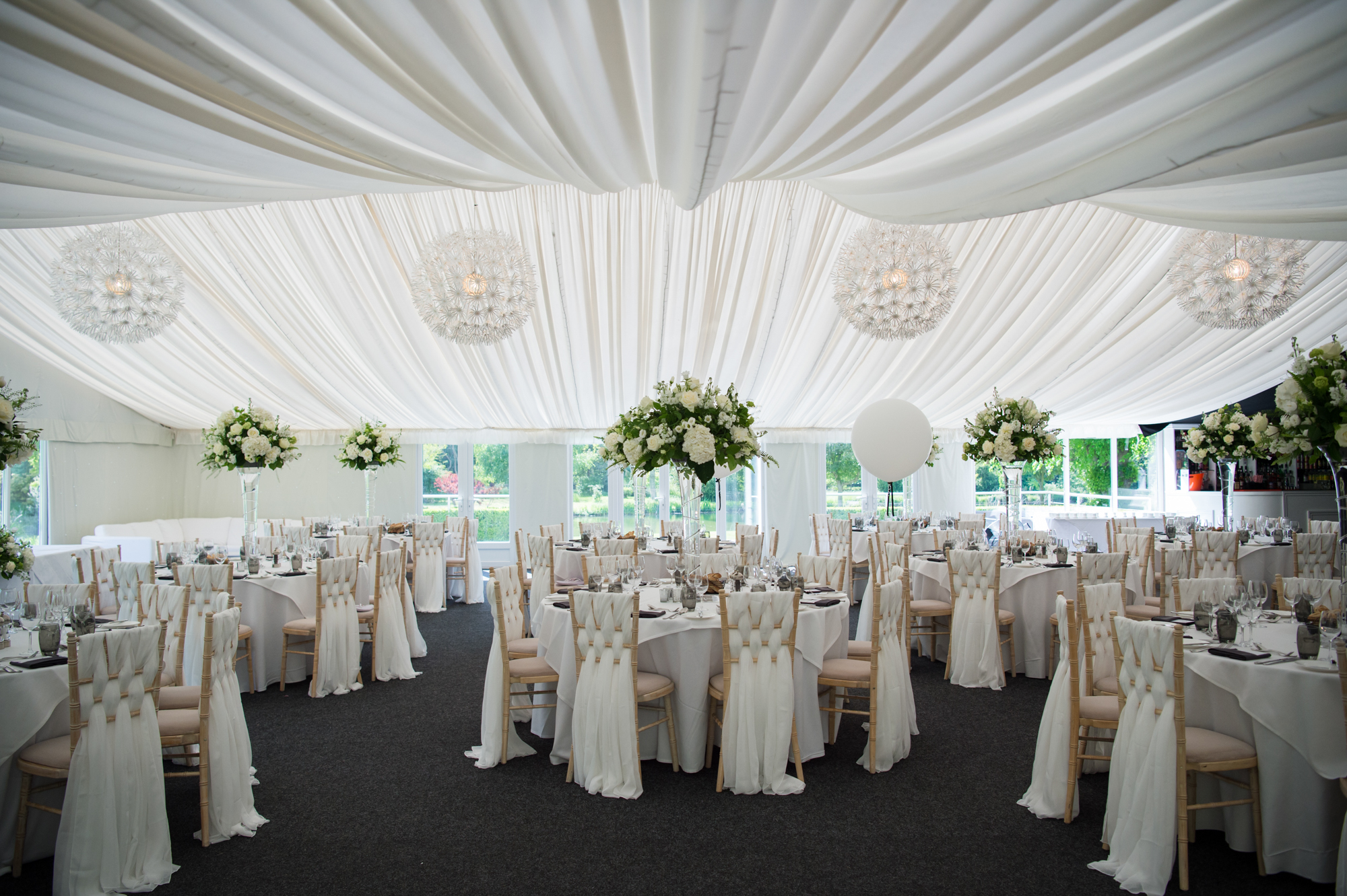 A white fabric pleated ceiling in a beautiful wedding marquee in Cambridgeshire